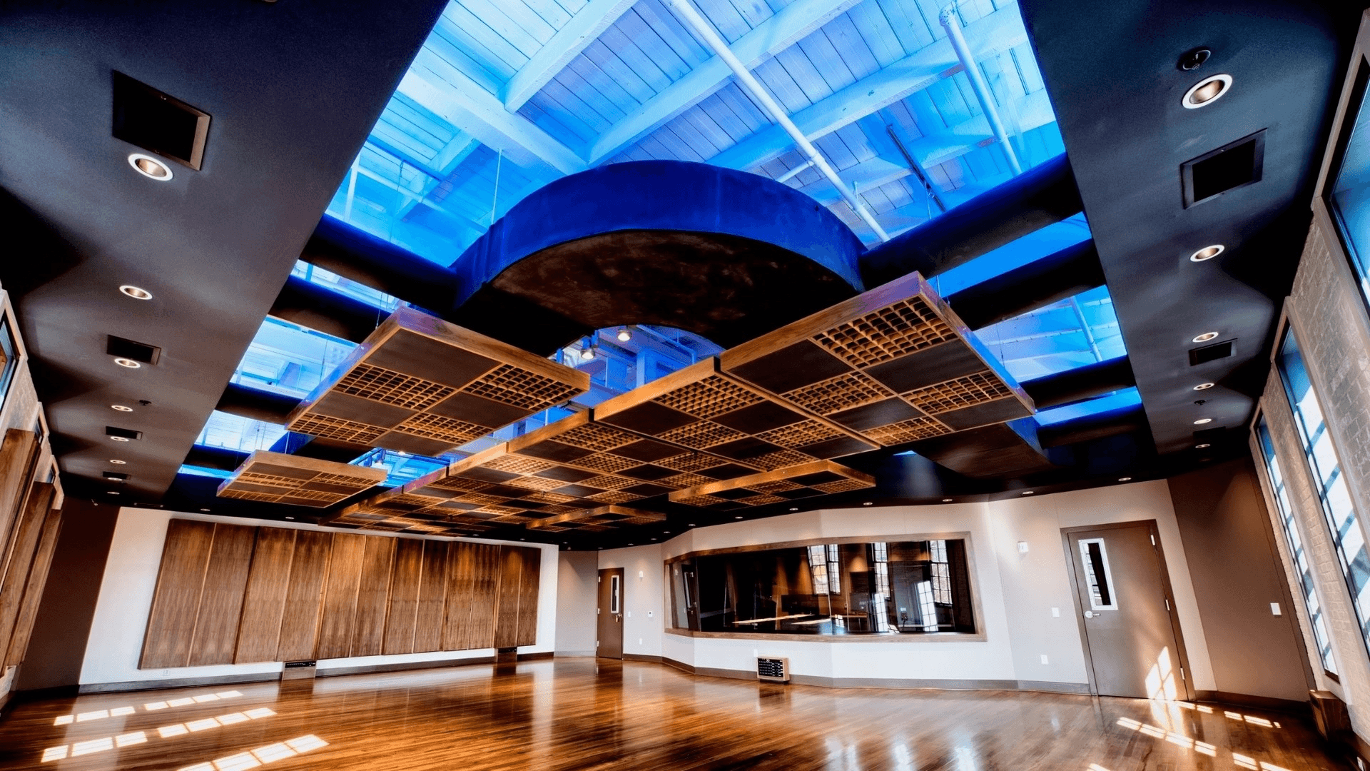 Large blue-lit production room inside Think Loud